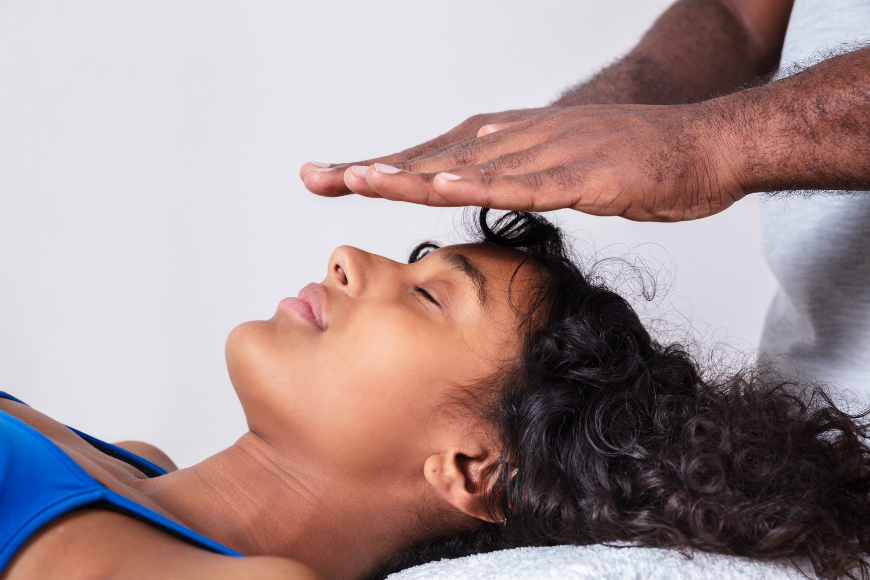 Woman Having Reiki Healing Treatment